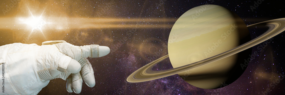 Wall mural astronaut pointing to planet saturn