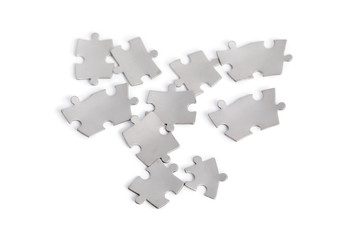 Metal puzzle pieces isolated on white