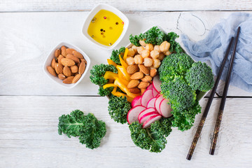 Healthy vegan buddha bowl with kale leaves and raw vegetables