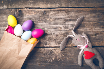 Easter bunny on old boards. Old board background. Rabbit. Easter ideas. Easter eggs. Space for text. Image in trendy toning.