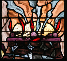 Stained Glass of a burning lamb, symbolizing the Agnus Dei © jorisvo