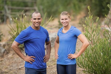 Fototapeta premium Fit man and woman standing with hands on hip 