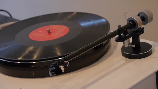 Classic stereo turntable player with musical vinyl record.