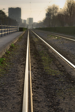 Empty tram rails at sunrise