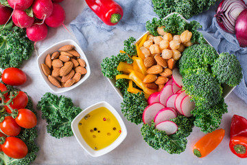 Healthy vegan buddha bowl with kale leaves and raw vegetables