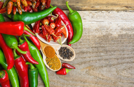 fresh red and green chili on old wood background. selective focus image, space for advertising text 