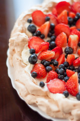 Pavlova dessert with raspberries and blueberries