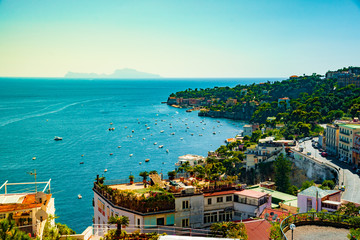 Naples bay scenic view, Italy. Travel background picture with blue sea and cityscape in golden light of evening.