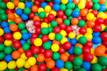 Fototapeta na wymiar Two boys playing in colored balls