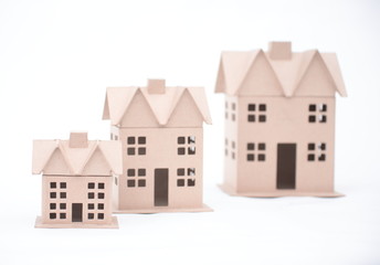 The concept, the house from the goffered cardboard, isolated on a white