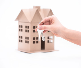 Real estate agent hand over property or new home keys to a customer on white