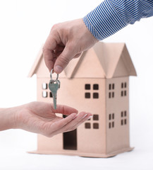 Real estate agent hand over property or new home keys to a customer on white