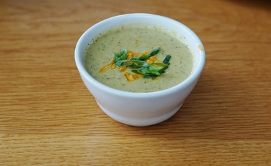 A cup of broccoli and cheddar soup
