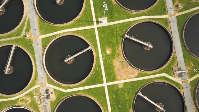 Sewage Farm: circular settling tanks - descending, vertical aerial drone