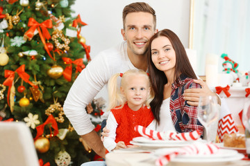 Portrait of happy family in living room decorated for Christmas
