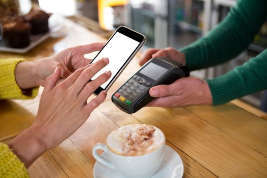 Barista accepting payment through smart phone