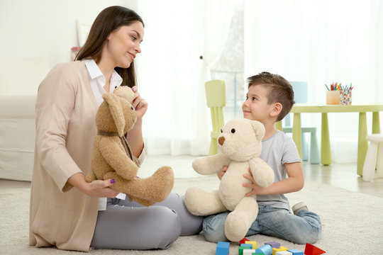 Young child psychologist working with little boy