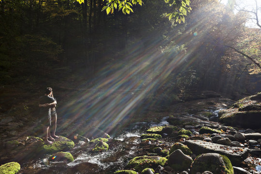 Young couple standing in a mossy stream