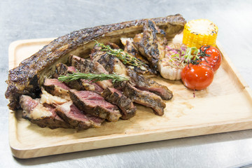 sliced barbecued tomahawk rib tip with rosemary, salt and herbs