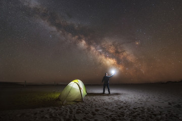 Midnight Explorer awakens from his tent to enjoy the night sky view