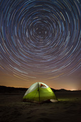 Earth spins while camping star trails - obrazy, fototapety, plakaty