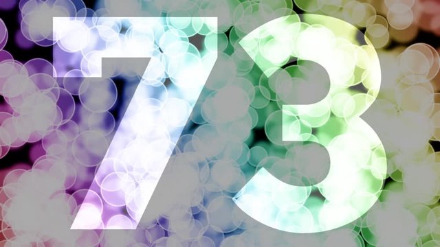 Seventy three to seventy four years birthday fade in/out animation with color gradient moving bokeh background. Animation: 90 frames still with number, 180 fade out, 30 clear, 180 fade in, 300 still.