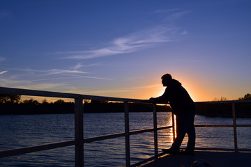 Fishing Sunset/Man standing on a dock at sunset fishing