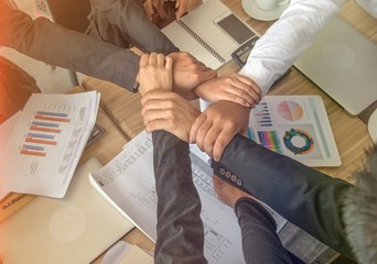 Group of people are hands on together for team building , together concept