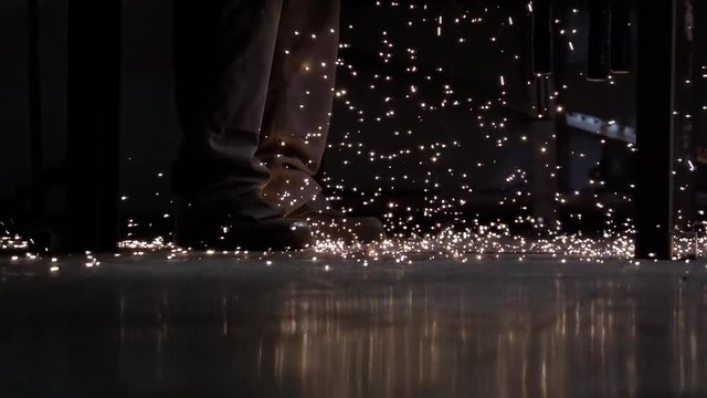 sparkling particles falling on ground and explode in the dark in slowmotion
