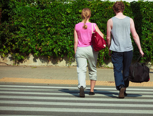 Obraz premium Couple man and woman with sport bags.