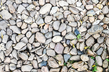 Stone background. Pile of stones on the ground.