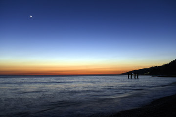 Sunset over the Black sea with a new moon