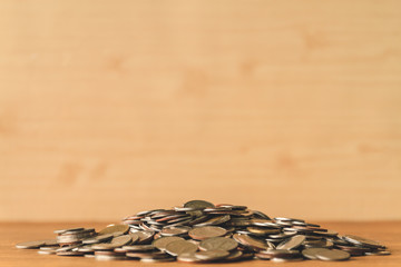Pile of coins on a wooden table. Financial Concept. Selective focus. Free space for text