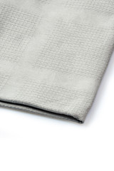 Obraz na płótnie Canvas Folded grey napkin on white background, close up