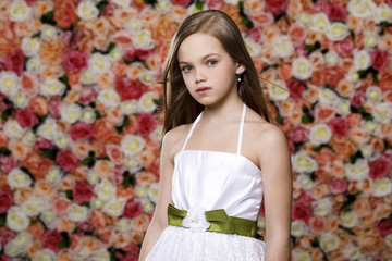 Portrait of a beautiful young little girl in white gown