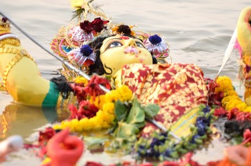 Immersion of goddess durga idol in river after completion of festival