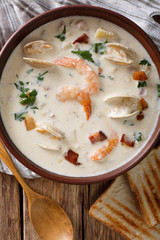 New England clam chowder soup close-up. Vertical top view