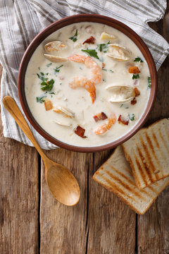 American cuisine: New England clam chowder soup closeup. Vertical top view