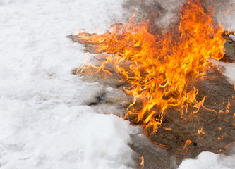 fiery flame on the white snow in winter