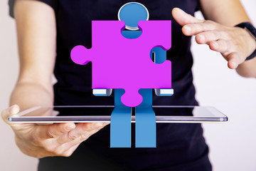 Person with tablet pc and puzzle piece