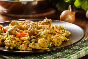 Fried rice nasi goreng with chicken and vegetables on a plate