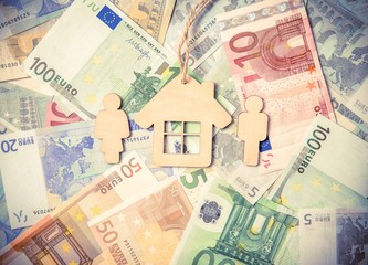 Symbol of home and family against the background of the Euro currency 