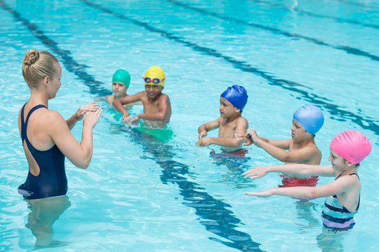 Swimming trainer instructing students