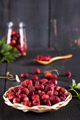 Berries of wild strawberries on a dark background.