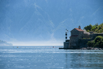 Sea lighthouse on a background of mountains
