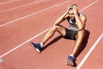 Young male athlete looking upset and devastated after losing in a competition