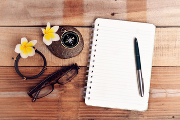 fountain pen with note book and Compass