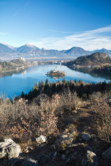 winter alpine scenic landscape with beautiful lake bled and island surrounded by julian alps in...