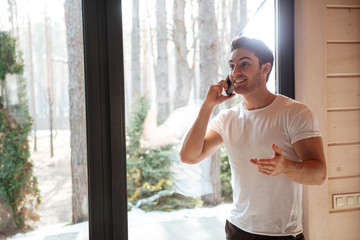 Man talking on phone in living room