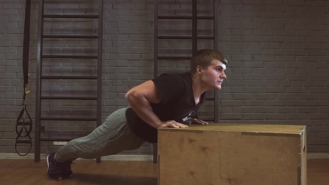Gym man push-up strength pushup in a fitness workout